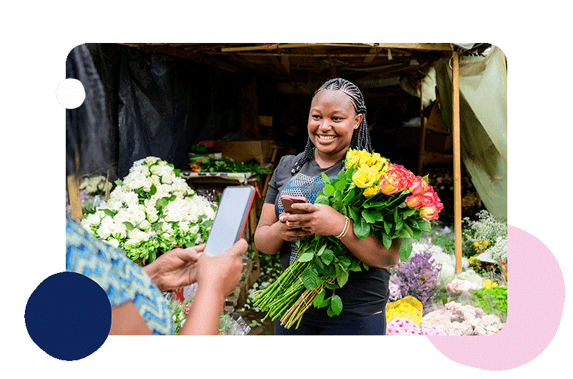 Person holding flowers at flower stall