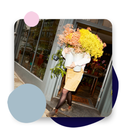 Person carrying flowers out of shop