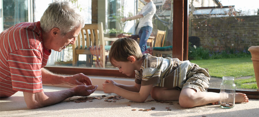 Child on floor playing with jigsaw