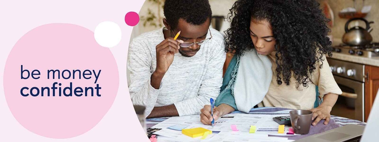 Two people looking at bills