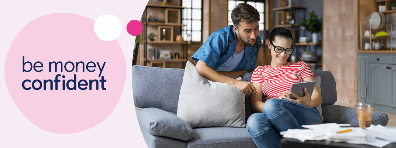 Couple on a sofa looking at a tablet.