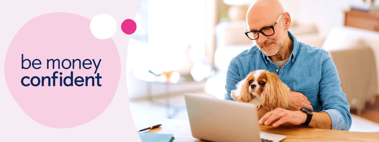 Man looking at laptop with dog