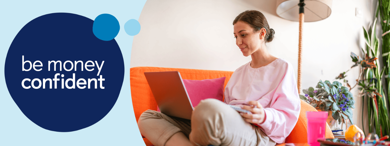 Person sat on sofa using laptop