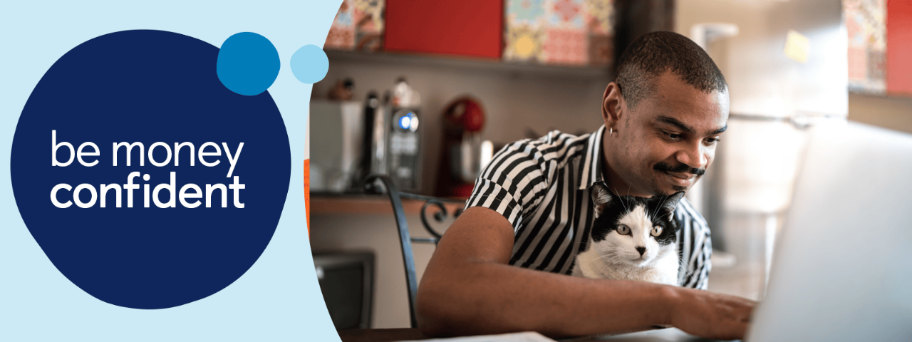 Man looking at laptop with cat