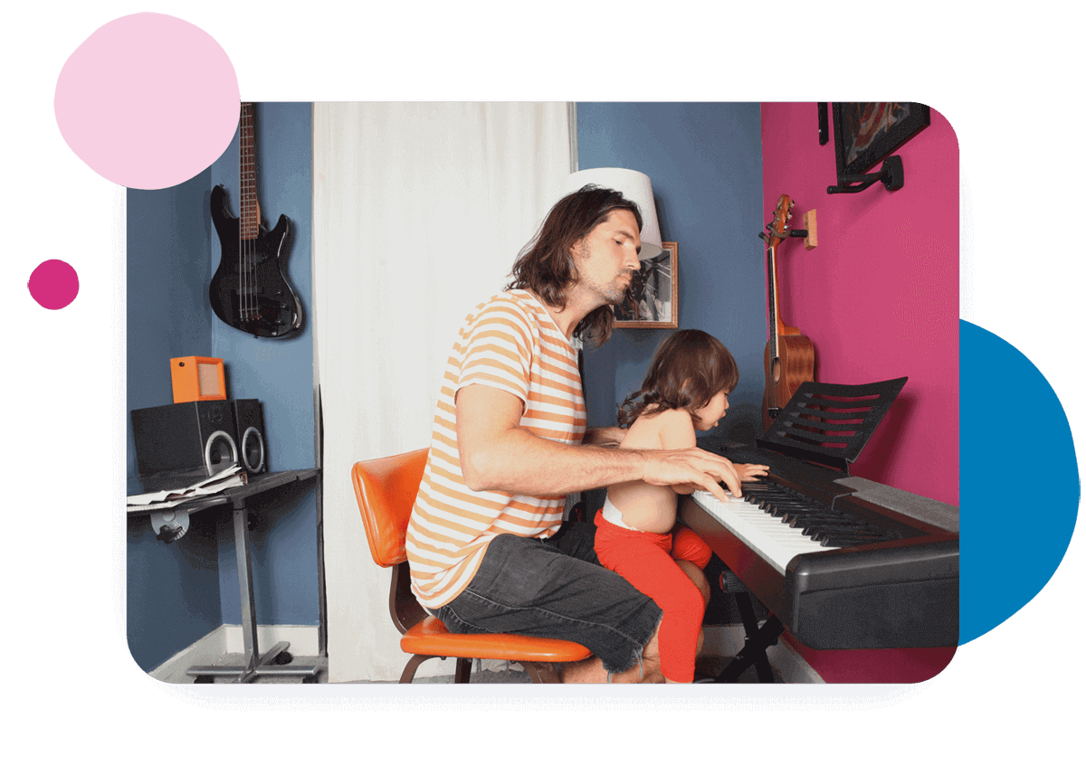 Person and child playing a keyboard.
