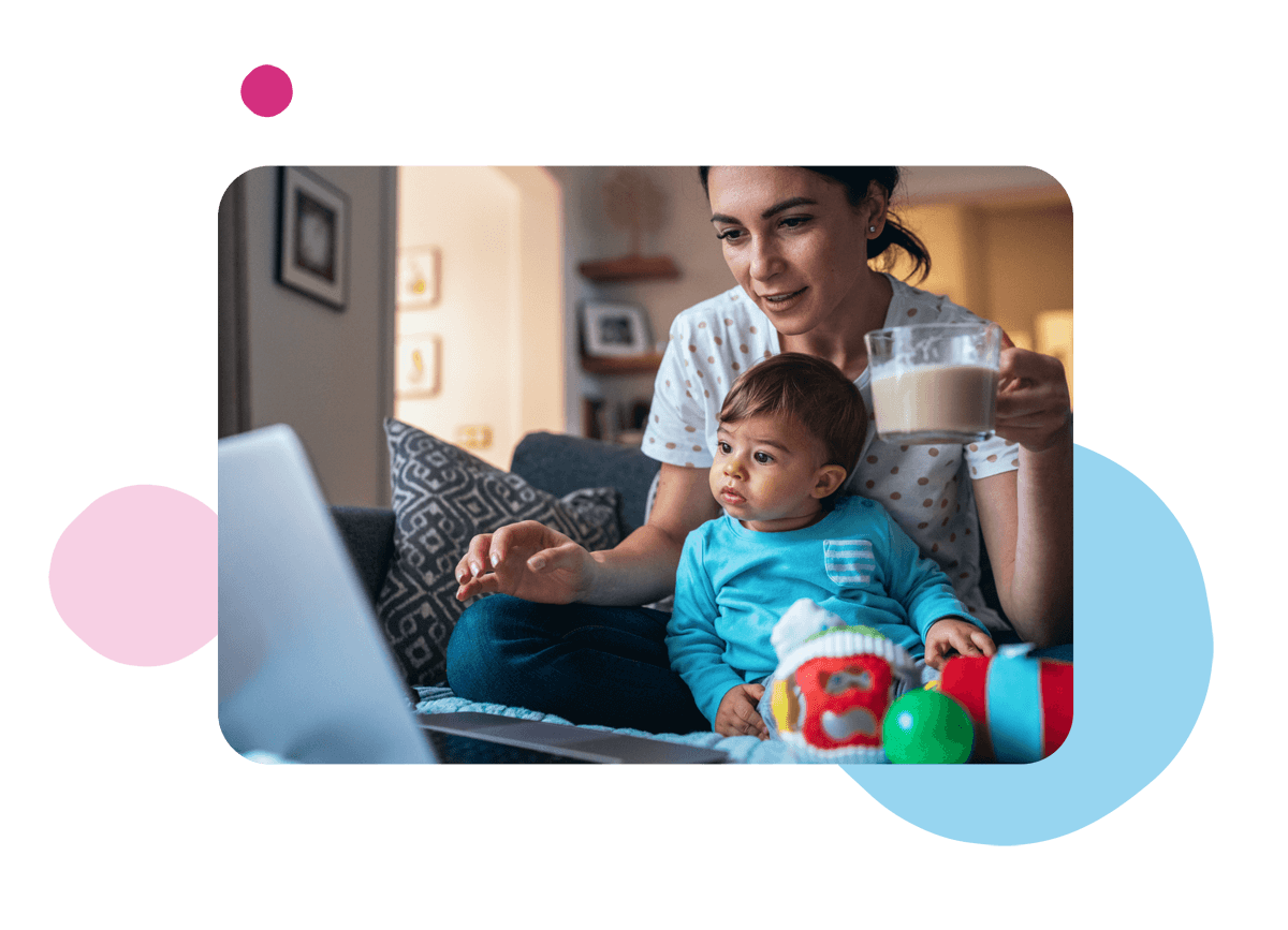 Person holding mug and child whilst on a laptop.